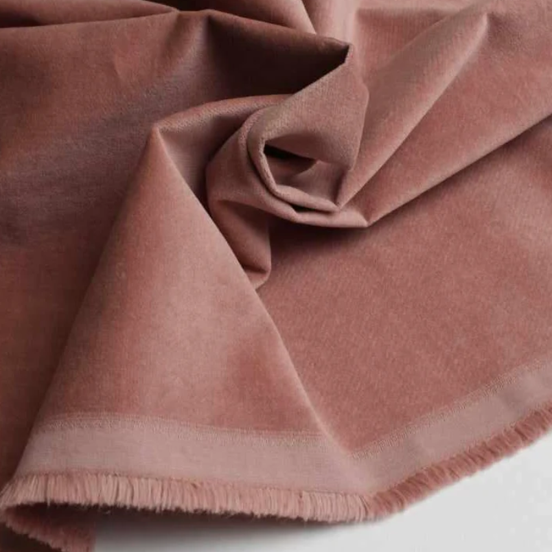 Layered interior featuring luxury textiles including velvet upholstery, silk drapery, and cashmere accents creating a refined and tactile living space